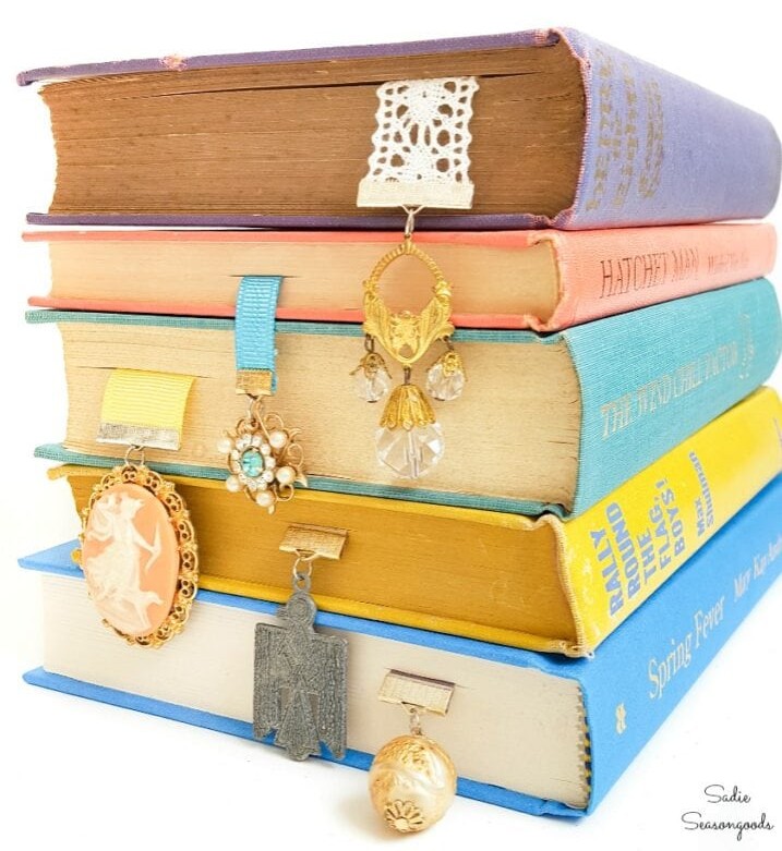 stack of books with homemade bookmarks inside